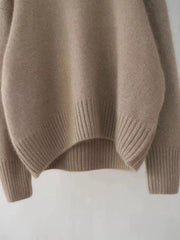 Cozy beige acrylic knit sweater with dropped shoulders and ribbed cuffs and hem.