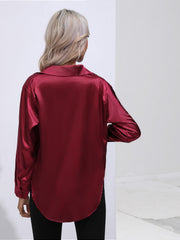 Burgundy satin tie-front blouse with a collared neckline and long sleeves.