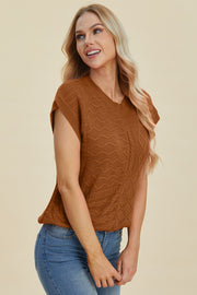 Brown knit patchwork sleeveless top with textured patterns and cable knit detail.