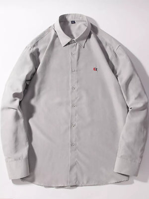Light gray button-up shirt with red embroidered logo detail