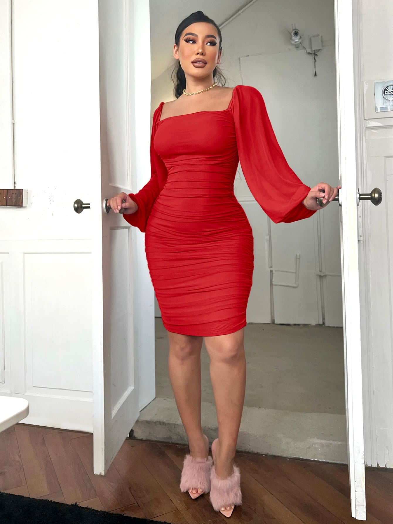 Red ruched bodycon dress with sheer puff sleeves and square neckline.