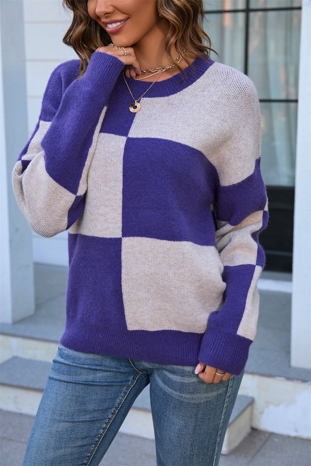 Checkerboard knit crewneck sweater in indigo and beige acrylic with a relaxed fit.