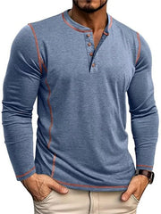Men's blue long sleeve henley t-shirt with contrast stitching and button detail.