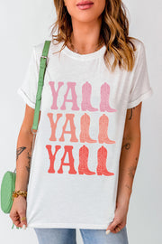 White graphic tee with "Y'all Boots" in pink and coral ombre text and cowboy boot graphics.