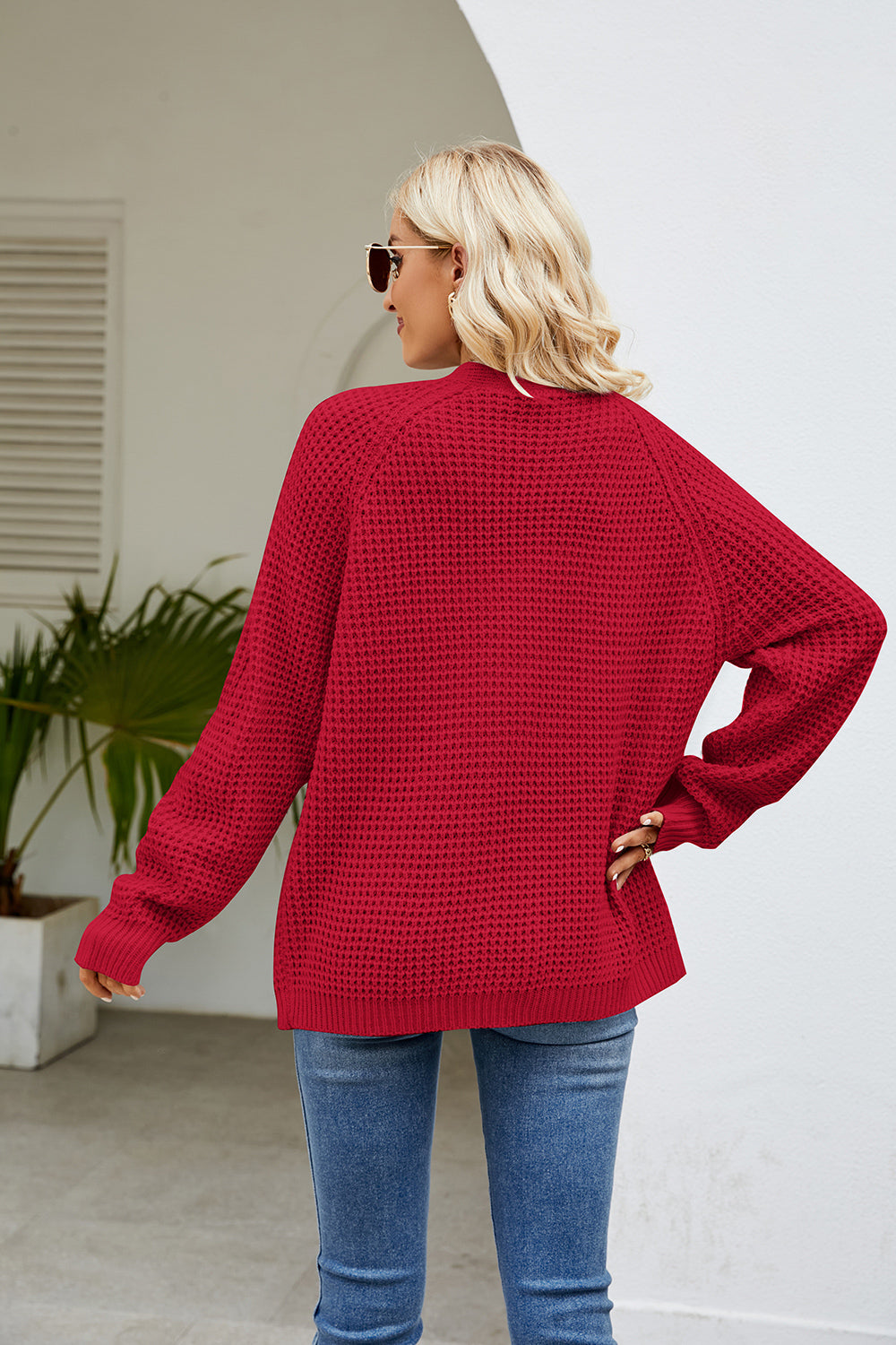 Red waffle knit raglan sleeve cardigan with ribbed cuffs and hem
