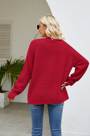 Red waffle knit raglan sleeve cardigan with ribbed cuffs and hem