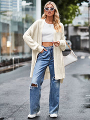 Cream open-stitch waffle knit duster cardigan with open front and long sleeves.