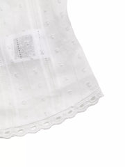 White sleeveless maternity blouse with dobby dots, vertical stripes, and lace trim hem.