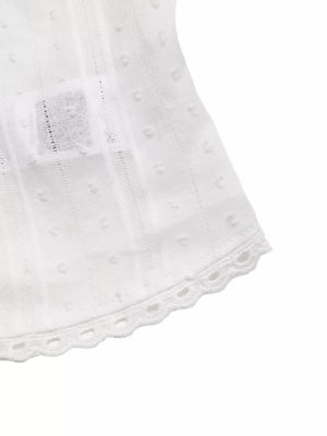 White sleeveless maternity blouse with dobby dots, vertical stripes, and lace trim hem.