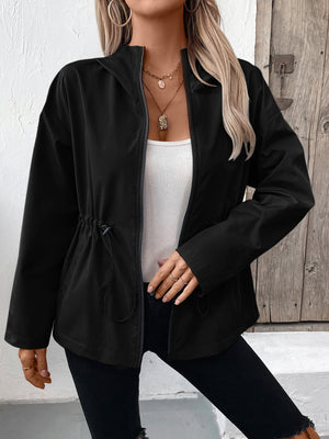 Black cinched waist utility jacket with drawstring detail and zip front, styled with a white tank top.