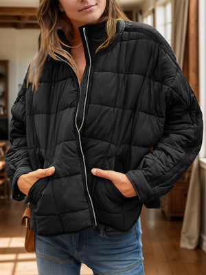 Black quilted bomber jacket with stand collar and zip front.