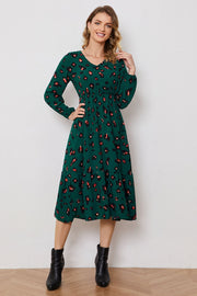 Emerald leopard print midi dress with v-neck, balloon sleeves, and tiered skirt.
