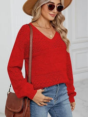 Red diamond eyelet knit V-neck sweater with long sleeves and textured details.