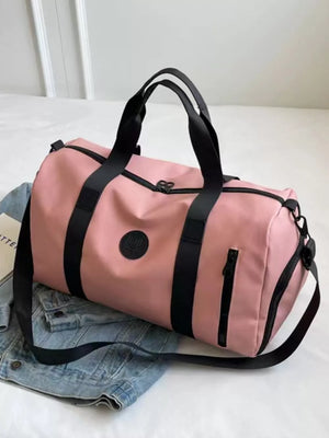 Pink travel organizer bag with black straps and adjustable shoulder strap.