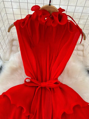 Red ruffled tiered midi dress with belted waist and tie neck.