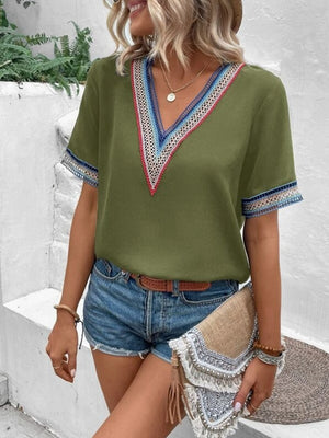 Matcha green v-neck top with embroidered trim on neckline and sleeves
