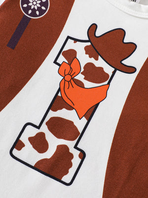 Baby bodysuit with cow print number 1, cowboy hat and orange bandana graphic.