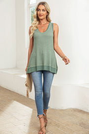 Sage waffle knit tank top with asymmetric hem and scoop neck, styled with jeans.