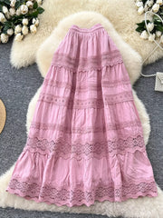 Pink tiered maxi skirt with lace trim and drawstring waist.