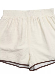Beige shorts with elastic waistband and brown trim detail