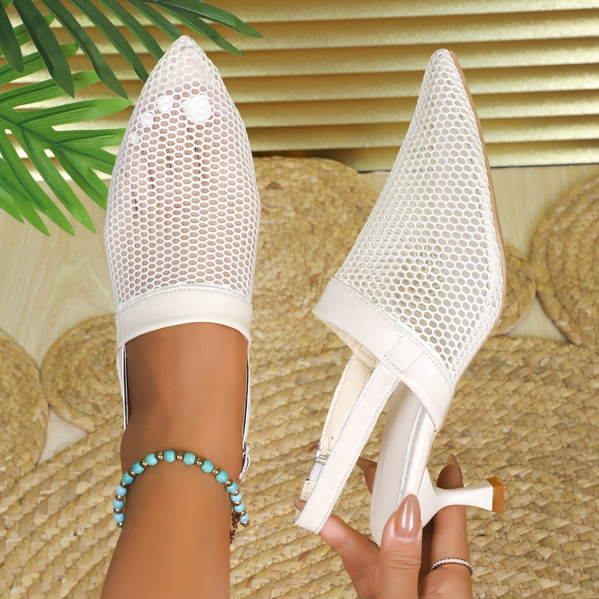 Beige mesh kitten heel sandals with pointed toe and slingback strap.