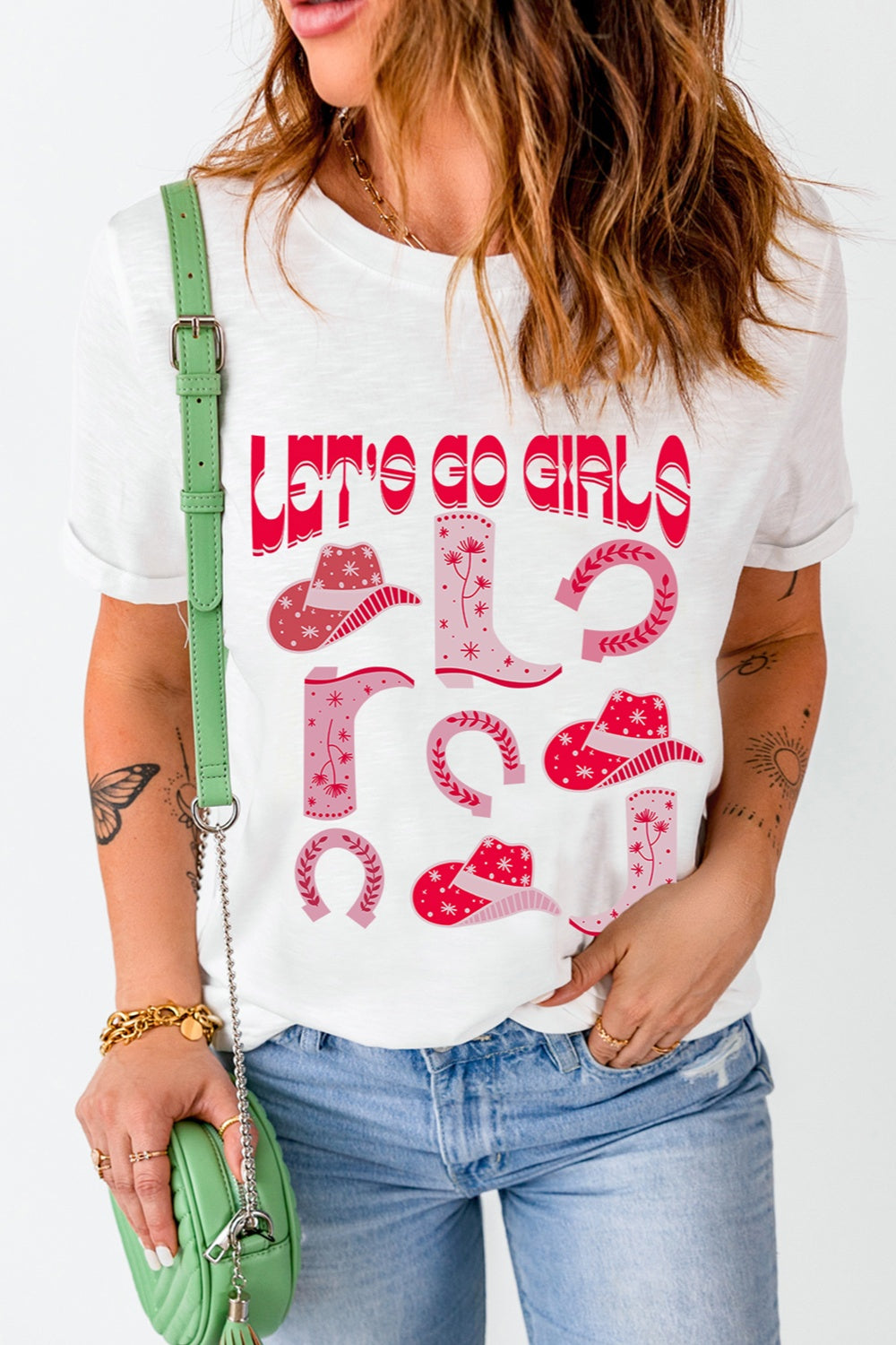 White graphic t-shirt with "Let's Go Girls" text and western icons like cowboy boots and hats.