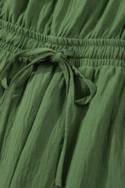 Textured drawstring palazzo jumpsuit in Matcha Green with crinkled fabric detail.