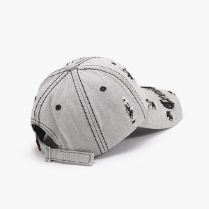 Distressed baseball cap in black with embroidered text and adjustable strap.
