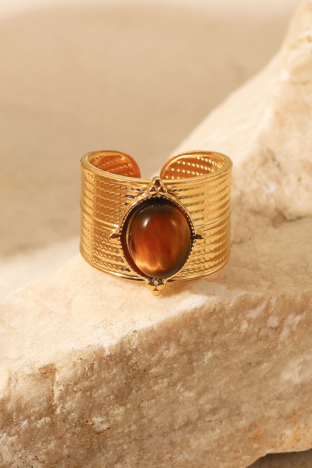 Textured gold cuff ring with oval brown tiger's eye stone