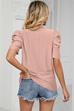 Blush pink perforated puff sleeve top with a textured diamond pattern.