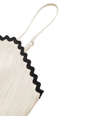 Cream cami dress with black scalloped contrast trim detail and textured fabric.