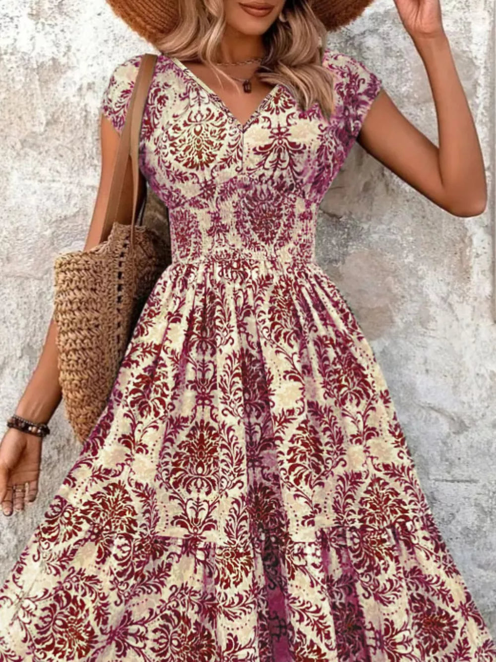 Maxi dress with smocked bodice, V-neck, short sleeves, and tiered skirt in a damask pattern.