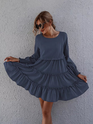 Navy blue ruffled mini dress with long sleeves and tiered skirt.