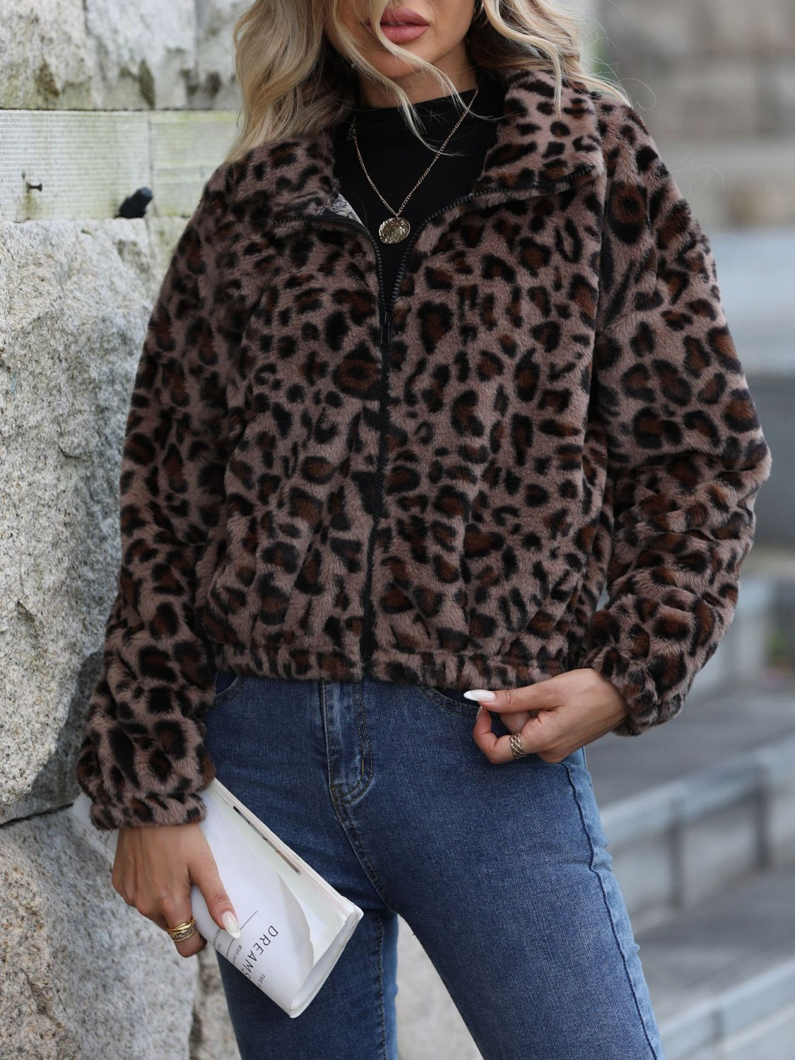 Leopard print zip-up jacket with a fuzzy texture and collar.