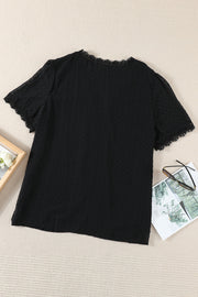 Black textured dot blouse with lace trim neckline and sleeves.
