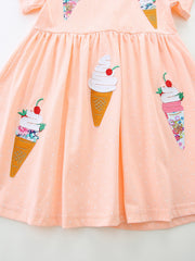 Peach cotton toddler dress with polka dots and playful ice cream cone appliques.
