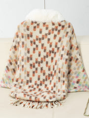 Textured plaid acrylic poncho with faux fur collar and fringe detail.