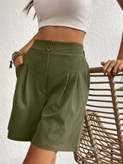 Pleated front bermuda shorts in olive green with double button closure and side pockets.