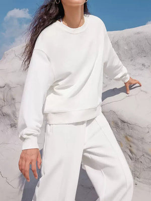 White seamed sweatshirt with crewneck and wide-leg lounge pants, casual loungewear set.