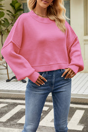 Boxy ribbed knit sweater in hot pink with crewneck and dropped shoulders.