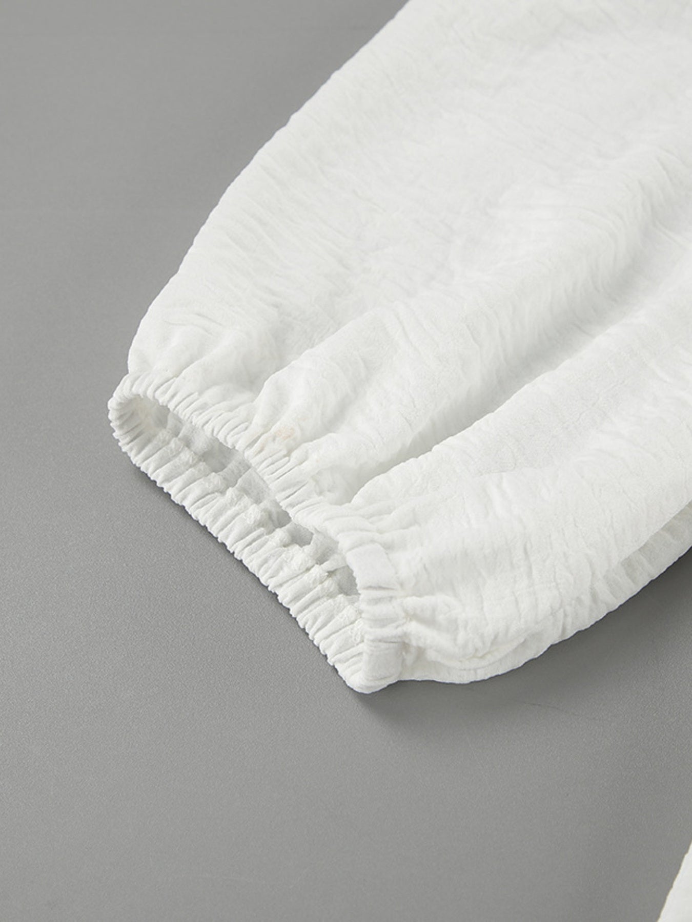 White textured midi dress with elasticated cuffs and sleeves.