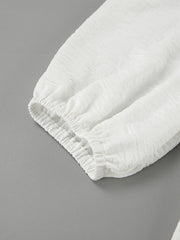 White textured midi dress with elasticated cuffs and sleeves.