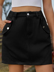 Black utility pocket mini skirt with elastic waist and buttoned flap pockets.