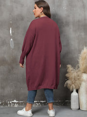 Burgundy oversized knit duster cardigan with patch pockets and ribbed cuffs.