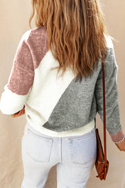 Geometric colorblock knit sweater in white, multicolor, and grey with a relaxed fit.