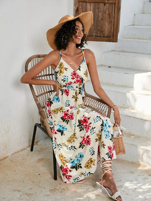 Chic floral midi dress with spaghetti straps in ivory with red, blue, and yellow flowers.
