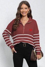 Burgundy zip knit sweater with white stripes, red heart patch, and quarter zip neckline.