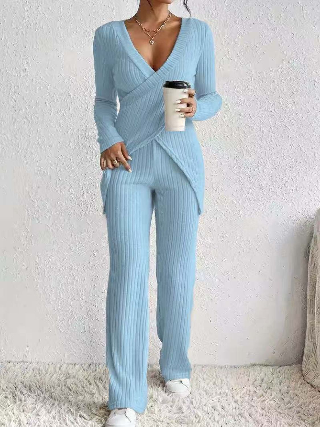 Pastel blue ribbed knit crossover lounge set with long sleeves and wide leg pants.