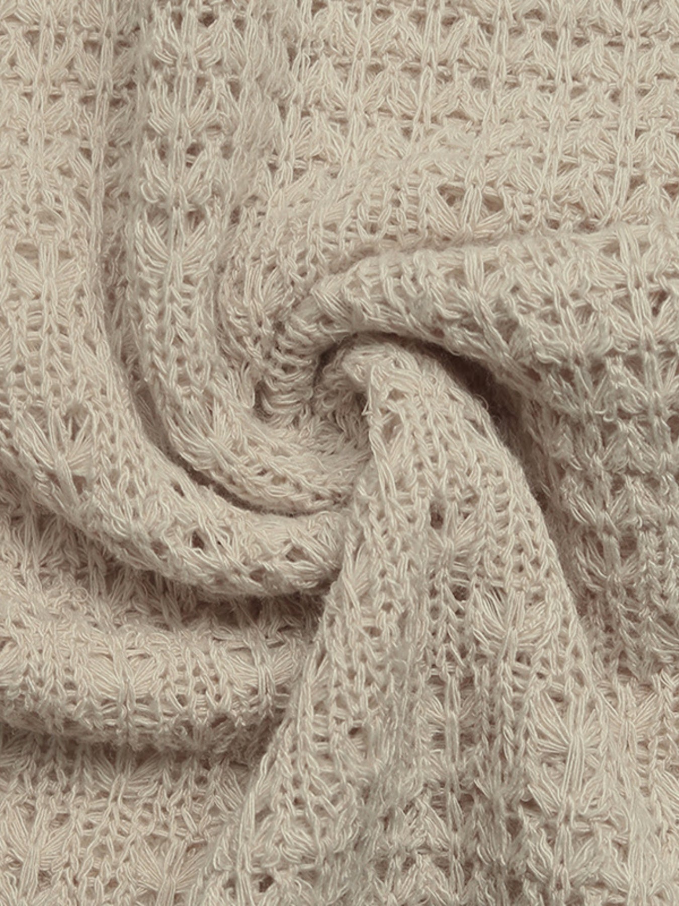Beige knit maxi dress fabric with open weave detail and textured pattern.