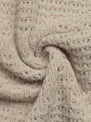 Beige knit maxi dress fabric with open weave detail and textured pattern.